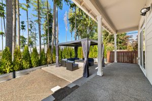 Landscaped Lacey backyard with a patio and pergola for outdoor gathering.