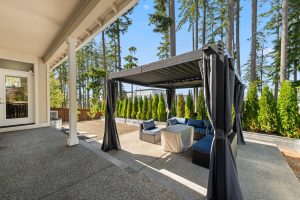 Landscaped Lacey backyard with a patio and pergola for outdoor gathering.