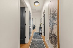 Hallway of the updated Lacey home with fresh interior finishes and LVP flooring.