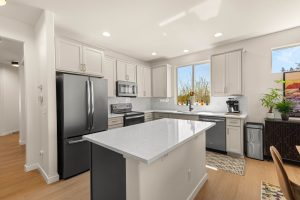Large kitchen island with quartz countertop in the updated Lacey home.