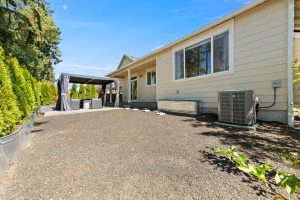 Refreshed low-maintenance backyard landscaping with fruit trees at the Lacey property.