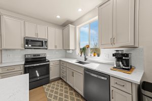 Remodeled kitchen in the Lacey home featuring quartz countertops and updated finishes.